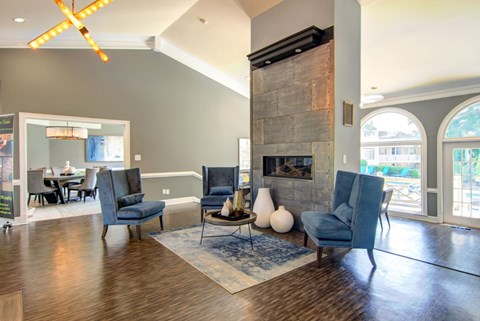 a living room with a fireplace and chairs